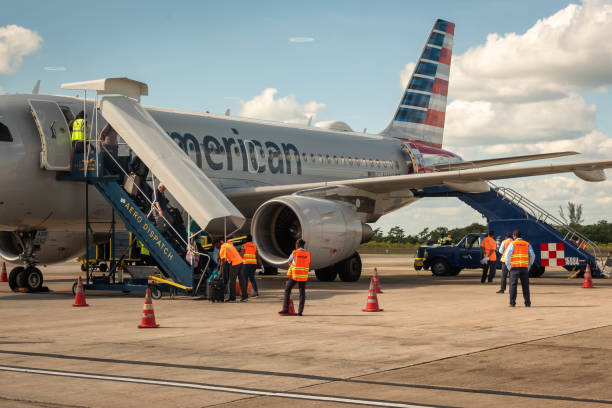 Belize City, Belize - November, 18, 2019. Passengers get off Americal Airline airplane arriving to Philip S W Goldson Airport.